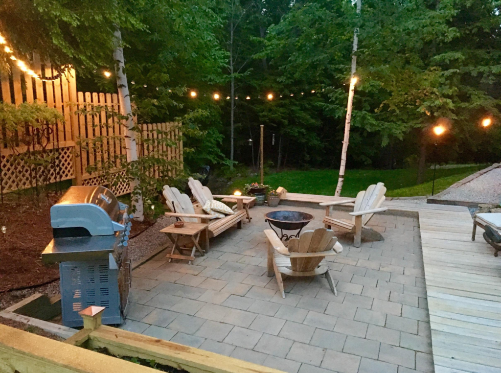 view of newly renovated patio with concrete interlocking and wood furniture