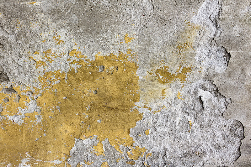 Slab of damaged, discoloured concrete