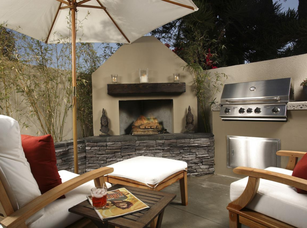 outdoor kitchen patio design using concrete with a fireplace