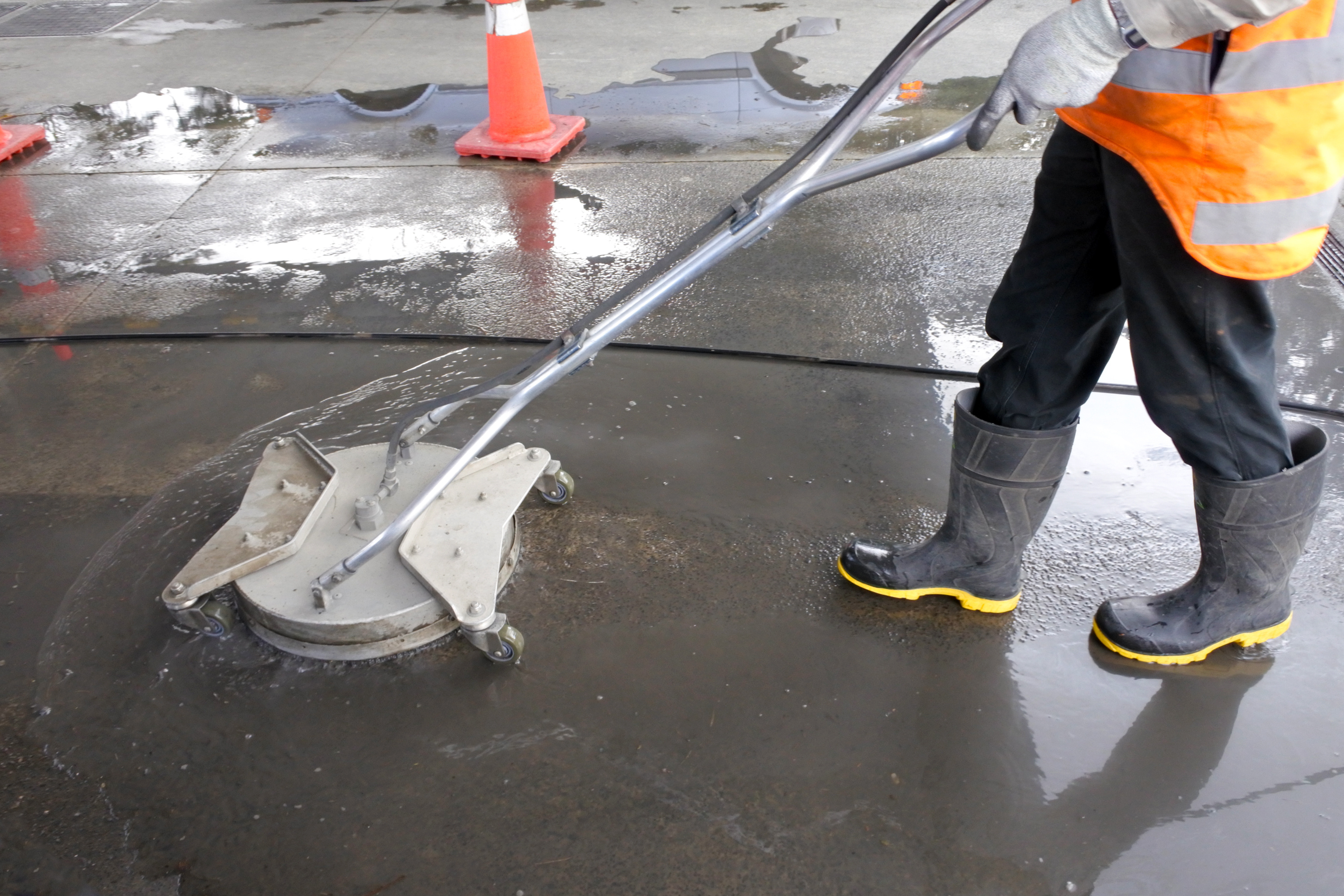 Construction worker spreading ready mixed concrete around
