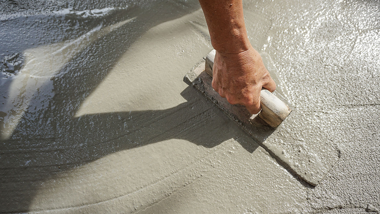 Worker smoothing out concrete